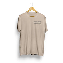 Cargar imagen en el visor de la galería, Beige t-shirt with 'BIG DOG COFFEE' text on a hanger against a white background