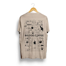 Cargar imagen en el visor de la galería, Beige t-shirt with 'Big Dog Coffee' graphic design on a hanger against a white background
